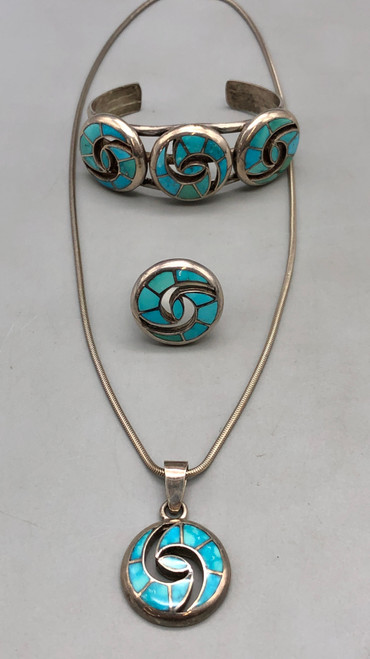 flush, turquoise channel inlay, geometric design on a ring, bracelet, and pendant