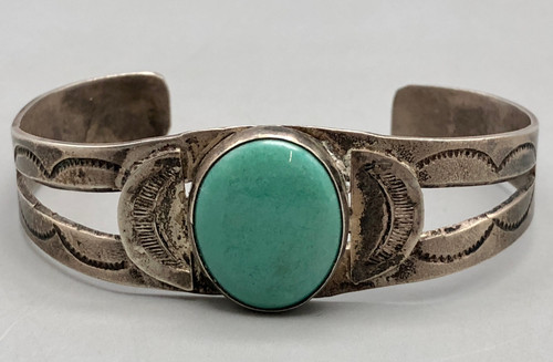 turquoise and sterling silver bracelet, 1930s-1940s era, central turquoise cabochon, smooth bezel, hand stamped designs, 2 wire terminal, conjoined ends