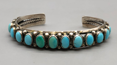 15 natural turquoise stones, darkened silver background, three wire terminal,
