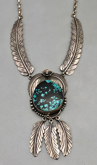 Circa 1980s, large pendant with turquoise stone, dangling leaves,