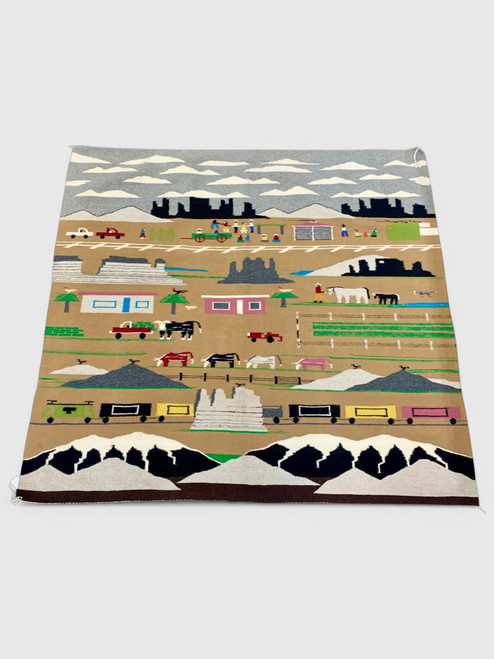 Large pictorial Navajo textile, mountains, clouds, people, cars and truck, a train, cows, horse, chickens, dogs