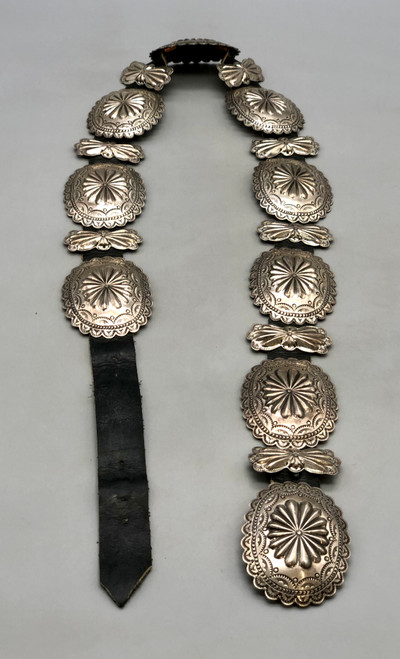 vintage, oval conchos, butterfly conchos, repousse flower design, hand stamped designs, scalloped edges, black leather belt.