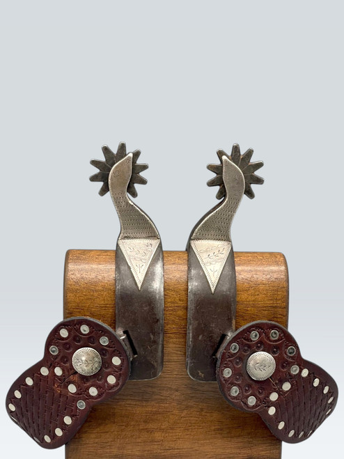 Ray Anderson, swan neck spurs,, engraved silver appliques, diamond shape incised silver plates, silver heel buttons, basket weave pattern.