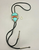 Carved turquoise and coral bolo tie