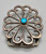 sandcast and turquoise belt buckle, flower or wave like design, turquoise cabochon