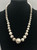 vintage Navajo pearl necklace, graduating sizes, conjoined by silver findings and strung on a link chain