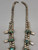 unique squash blossom necklace set with a matching ring, great turquoise nugget cabochons throughout the naja and blossoms, silver applique