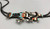 Crown Dancer inlay bolo tie, channel inlay of turquoise, mother of pearl, onyx, coral, silver dots and other silver pieces woven into the design