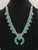 Zuni style petit point turquoise squash blossom necklace, petit point and "snake-eye" turquoise cabochons, four petal blossoms