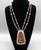 vintage coral cluster necklace, sawtooth bezels set in a shadowbox style display, straight lines, silver dots, triangular cut-outs
