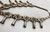 vintage unique style squash blossom necklace, fleur-de-lis style naja, natural turquoise, sterling silver, coated wire