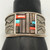 tufa cast and cobblestone inlay bracelet by Navajo artist, Harrison Jim, cobblestone inlay of wood, turquoise, onyx, and coral, geometric designs