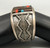 tufa cast and cobblestone inlay bracelet by Navajo artist, Harrison Jim, cobblestone inlay of wood, turquoise, onyx, and coral, geometric designs