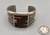 tufa cast and cobblestone inlay bracelet by Navajo artist, Harrison Jim, cobblestone inlay of wood, turquoise, onyx, and coral, geometric designs