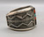 tufa cast and cobblestone inlay bracelet by Navajo artist, Harrison Jim, cobblestone inlay of wood, turquoise, onyx, and coral, geometric designs