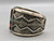 tufa cast and cobblestone inlay bracelet by Navajo artist, Harrison Jim, cobblestone inlay of wood, turquoise, onyx, and coral, geometric designs