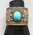 hefty turquoise and sterling silver bracelet, turquoise cabochon in a sawtooth bezel, twisted wire and silver applique