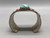 hefty turquoise and sterling silver bracelet, turquoise cabochon in a sawtooth bezel, twisted wire and silver applique