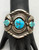 three-stone turquoise bracelet, turquoise cabochons in handmade sawtooth bezels, twisted wire, and intricate pieces of silver applique