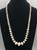 a stamped sterling silver bead necklace, medium length, strung on a silver chain