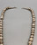 a stamped sterling silver bead necklace, medium length, strung on a silver chain