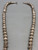 a stamped sterling silver bead necklace, medium length, strung on a silver chain