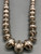 a stamped sterling silver bead necklace, medium length, strung on a silver chain