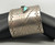 wide sterling silver and turquoise bracelet, two triangular turquoise cabochons