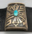 thick silver plate with a single gorgeous turquoise cabochon, lovely geometric overlay with a stippled, darkened background