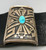 thick silver plate with a single gorgeous turquoise cabochon, lovely geometric overlay with a stippled, darkened background