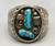 two turquoise cabochons surrounded by silverwork