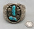 two turquoise cabochons surrounded by silverwork