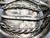 larger central turquoise stone, hand stamped designs, filework, twisted wire, silver dots, and silver applique