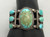 great antique seven stone turquoise bracelet, large center natural turquoise cabochon displayed in a smooth silver bezel, six matching natural turquoise cabochons, twisted wire and raised dots