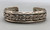 older handmade coin silver marked bracelet, carinated bands with conjoined ends, center twisted wire, hand stamped designs