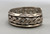 older handmade coin silver marked bracelet, carinated bands with conjoined ends, center twisted wire, hand stamped designs