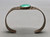 turquoise and sterling silver bracelet, 1930s-1940s era, central turquoise cabochon, smooth bezel, hand stamped designs, 2 wire terminal, conjoined ends