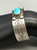 1930s, central turquoise cabochon, hand stamped designs, smooth silver cuff
