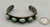 5 green turquoise stones, darkened silver background, silver dots