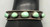 5 green turquoise stones, darkened silver background, silver dots