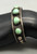 5 green turquoise stones, darkened silver background, silver dots