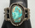 central turquoise cabochon, filework, darkened silver background, three wire terminal