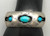 three turquoise cabochons, shadowbox cutouts, darkened silver, smooth silver cuff