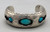 three turquoise cabochons, shadowbox cutouts, darkened silver, smooth silver cuff