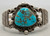 Chief Wolf Robe, blue turquoise, silver loops, darkened silver background, two wire split shank terminal stamped silver appliques,  Circa 1940s