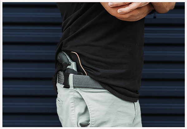 Man standing up straight showing holstered weapon in a black RapidTuck IWB holster