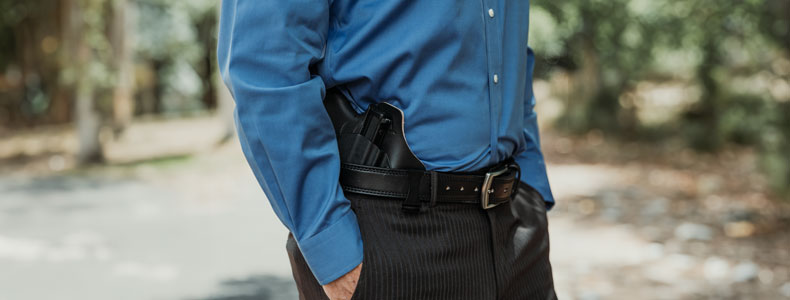 Man dressed formal while carrying on a 3 o'clock position a ComfortTuck IWB Holster from Vedder Holsters.