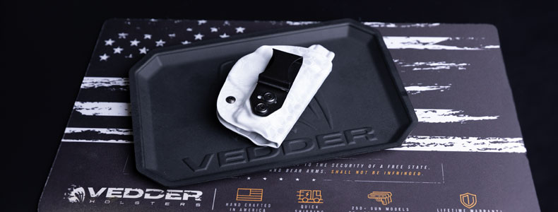 Product photography for Vedder Holsters EDC Tray holding our LightTuck IWB gun holster on top of our Gun Cleaning Mat.