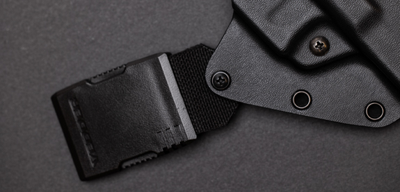 A finger presses into the soft foam of the HolsterPad