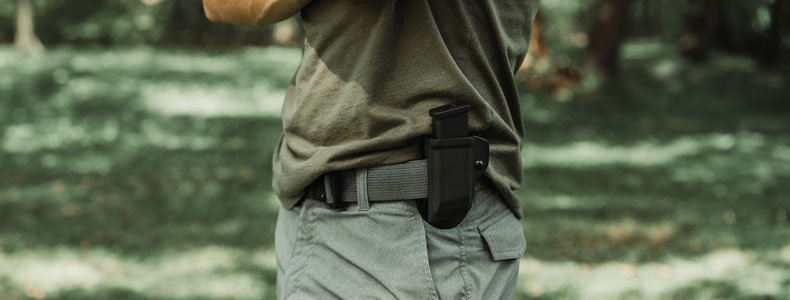 Man in the forest carrying a MagDraw Single OWB Holster from Vedder Holsters.